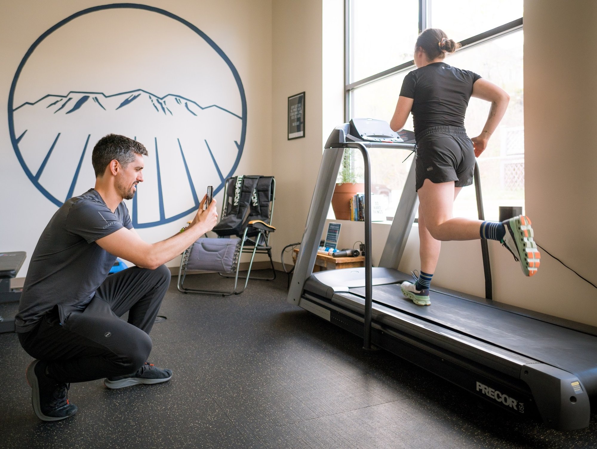 A Portland Maine Running Physical Therapist performs a gait analysis for a runner on a treadmill.