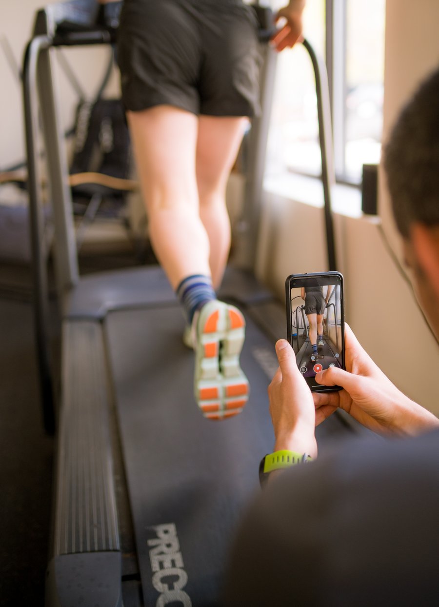 A close look at a runner's foot strike being filmed on the treadmill during a gait analysis.