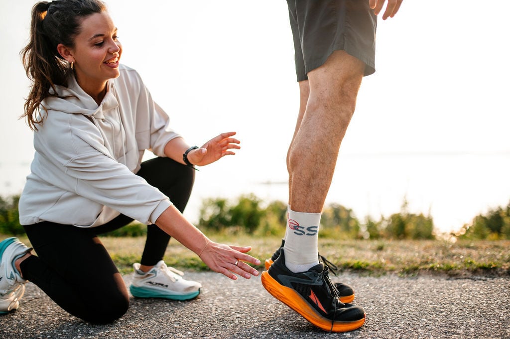 Dr. Helen Harrod Clark helping a runner with calf raises.