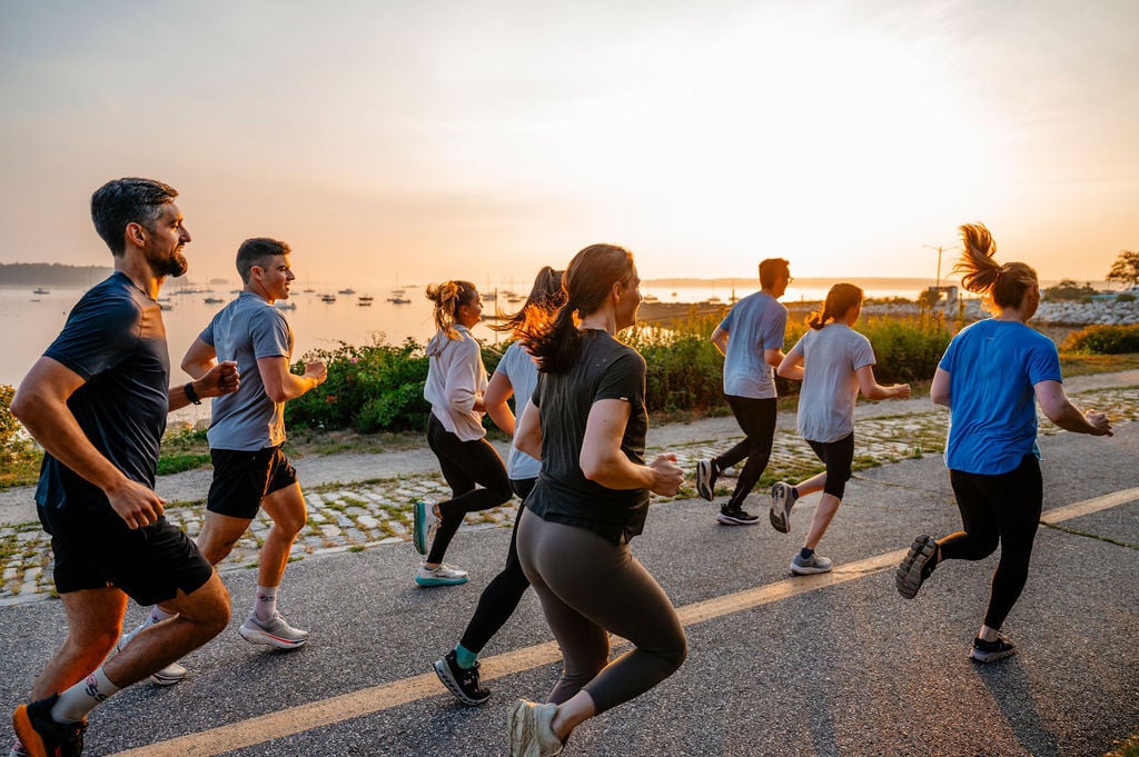 A group of runners on a coastal path at sunrise in Portland, Maine