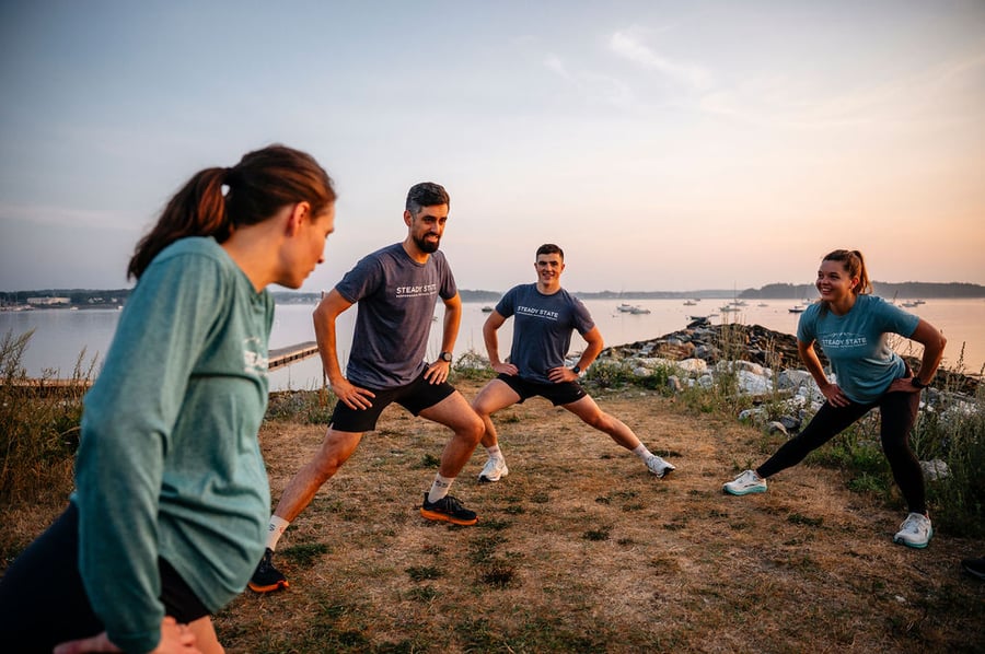A group of runners warming up together on the Eastern Prom in Portland, Maine.