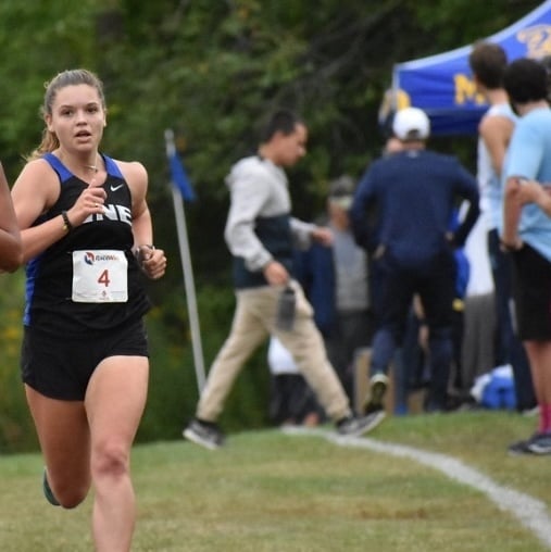 Helen running cross country for the University of New England