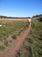 Kelton running on trail.