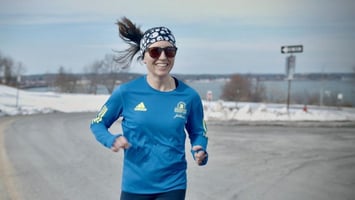 A runner smiling on a run.