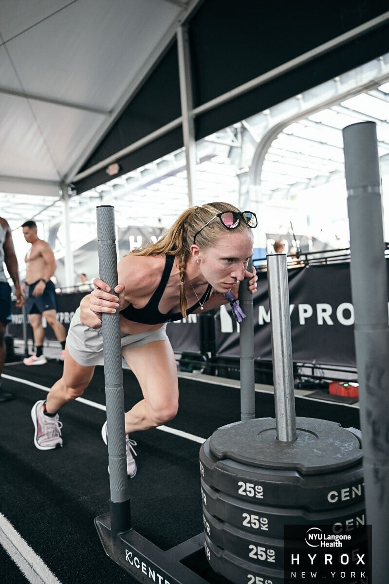 Brenna pushing the sled at Hyrox New York.