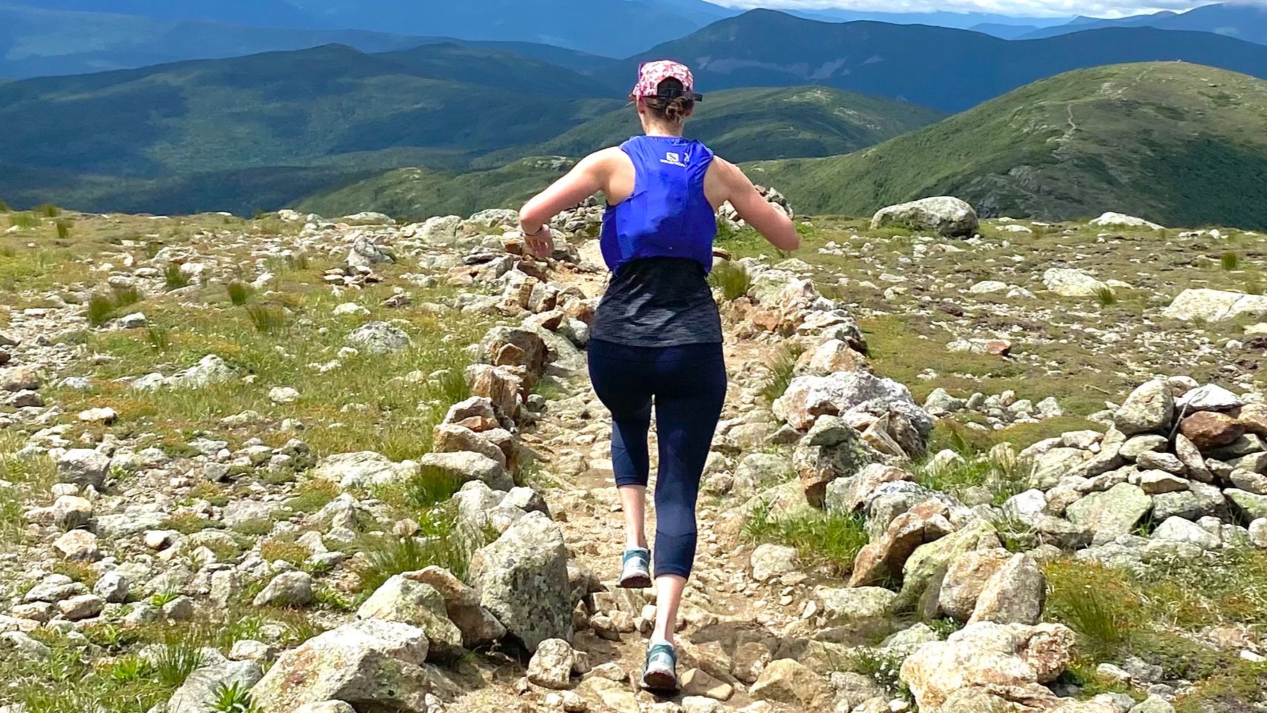 A trail runner running in the White Mountains of New Hampshire